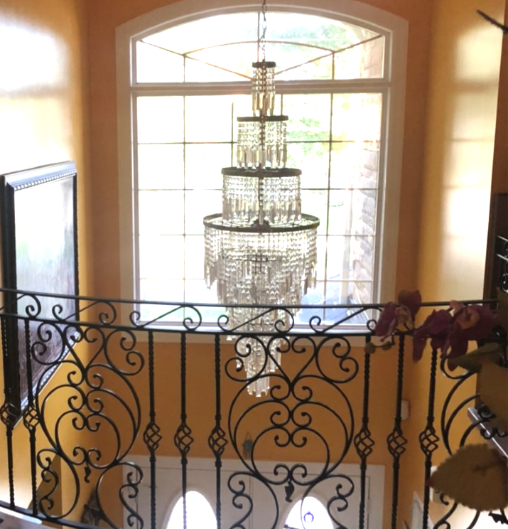 Elegant chandelier with wrought iron railing