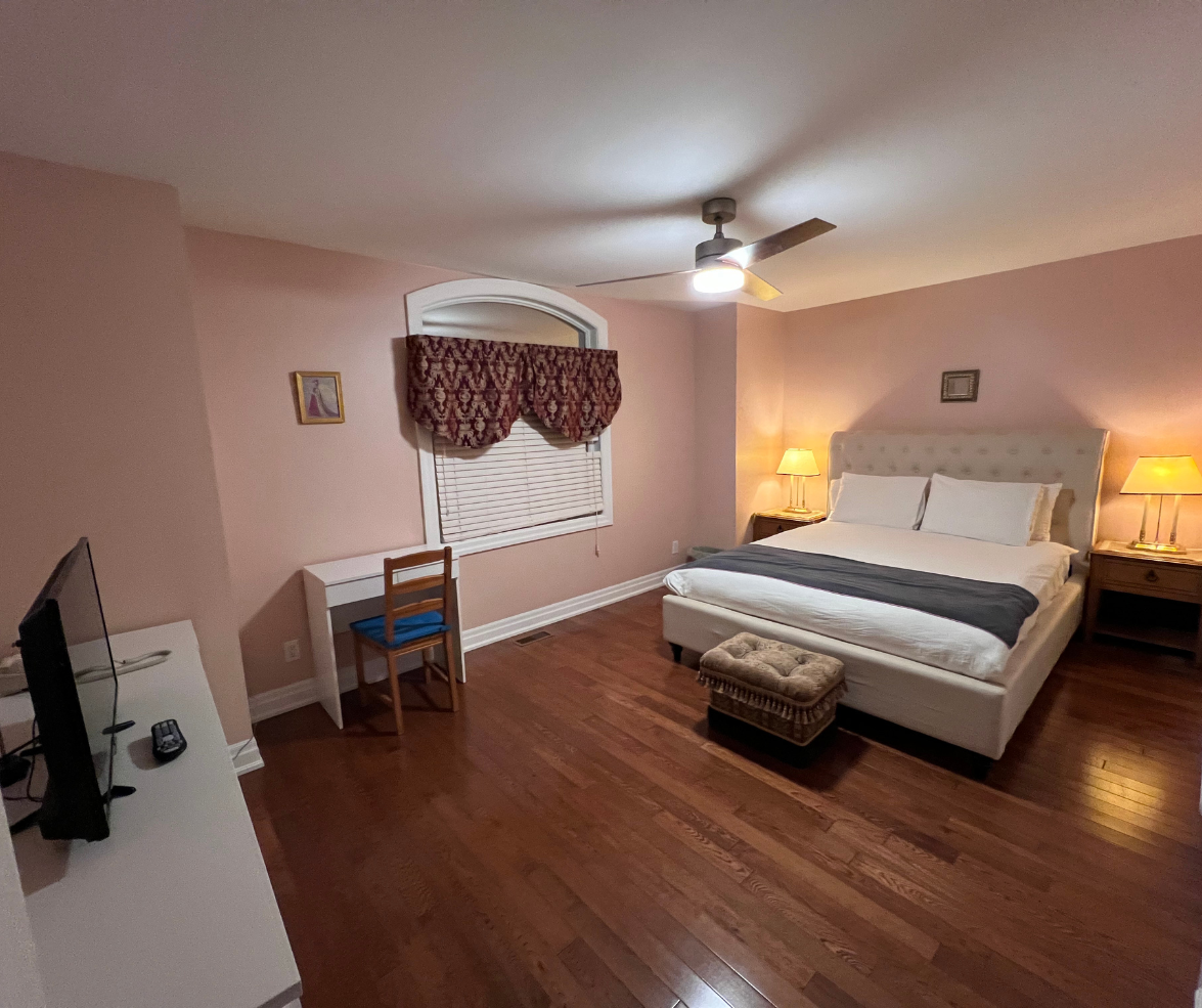 Elegant bedroom with queen bed and desk