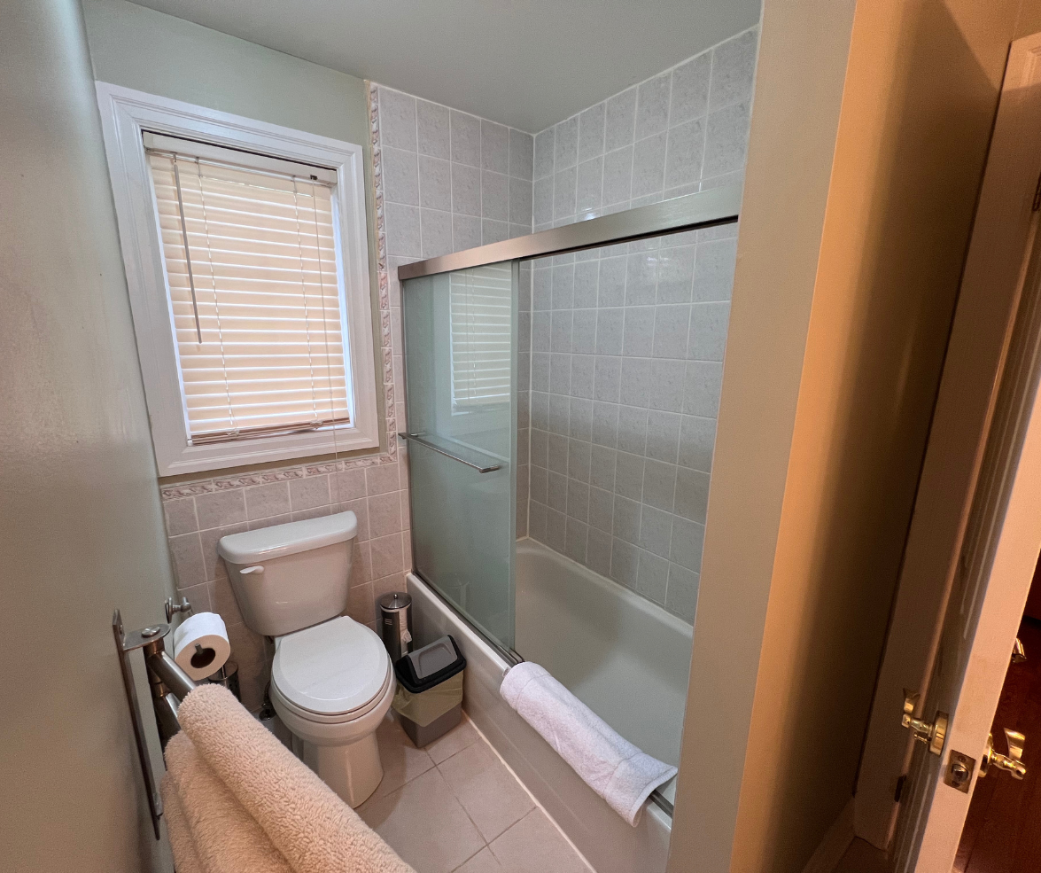 Clean bathroom with bathtub and window