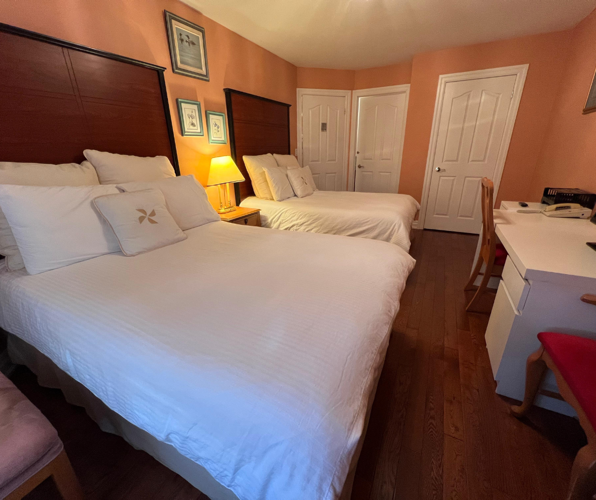 Room with two double beds and desk