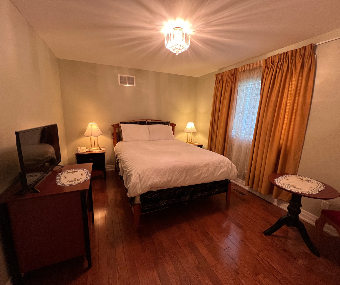 Cozy bedroom with queen bed and warm lighting